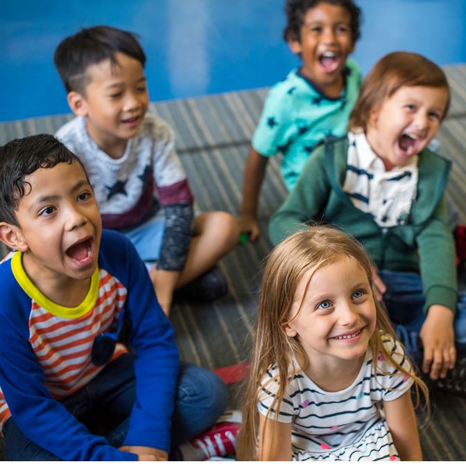 Attentive children listening to their caring teacher during story time in a bright, engaging classroom at Daily Bread Child Care Development Center