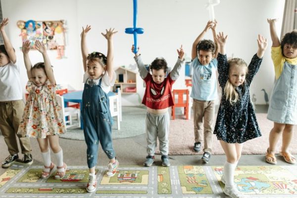Children enjoying music and movement activities with Ms. Frances, learning rhythm and coordination through keyboard lessons and dance
