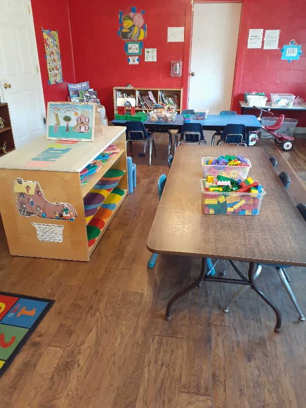 Children enjoying safe outdoor playground activities in the secure, fenced play area at Daily Bread Child Care Development Center